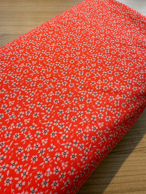 Jersey "Mini pâquerette" sur fond orange peps certifié oeko-tex (prix pour 10cm)