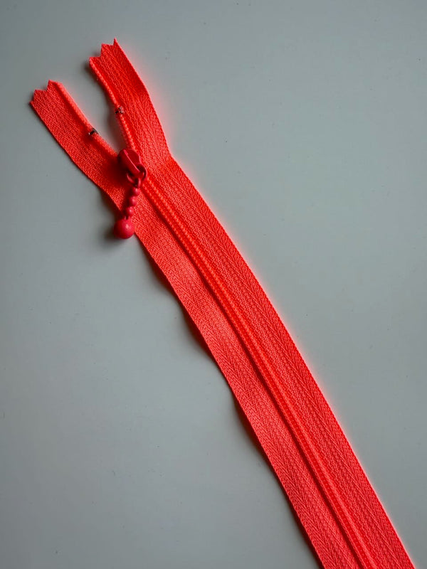 YKK - zip non séparable 20cm avec curseur décoration boule - couleur corail fluo (prix à la pièce)