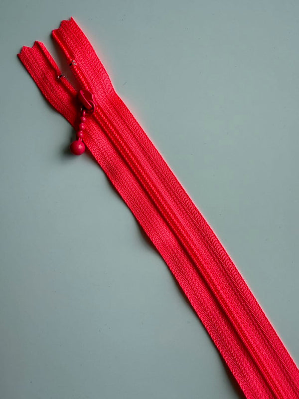 YKK - zip non séparable 20cm avec curseur décoration boule - couleur rose fluo (prix à la pièce)