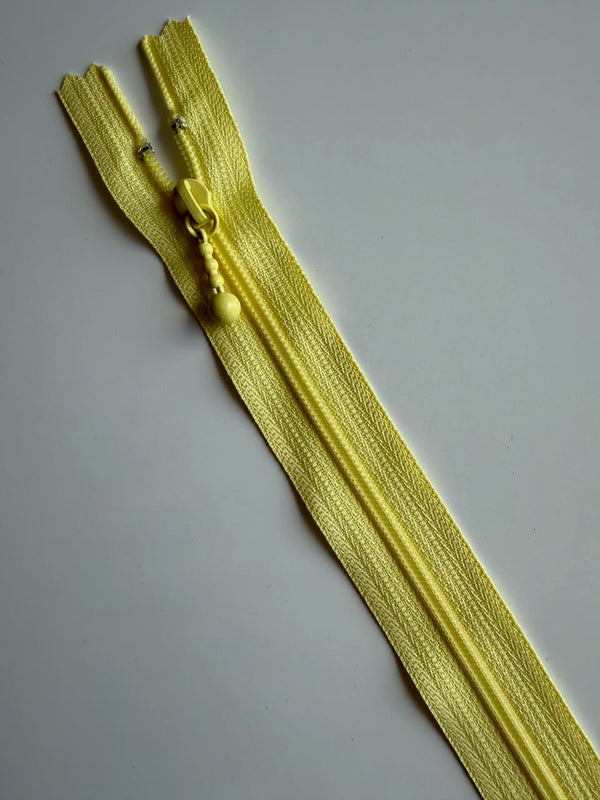 YKK - zip non séparable 20cm avec curseur décoration boule - couleur jaune pâle 802 (prix à la pièce)